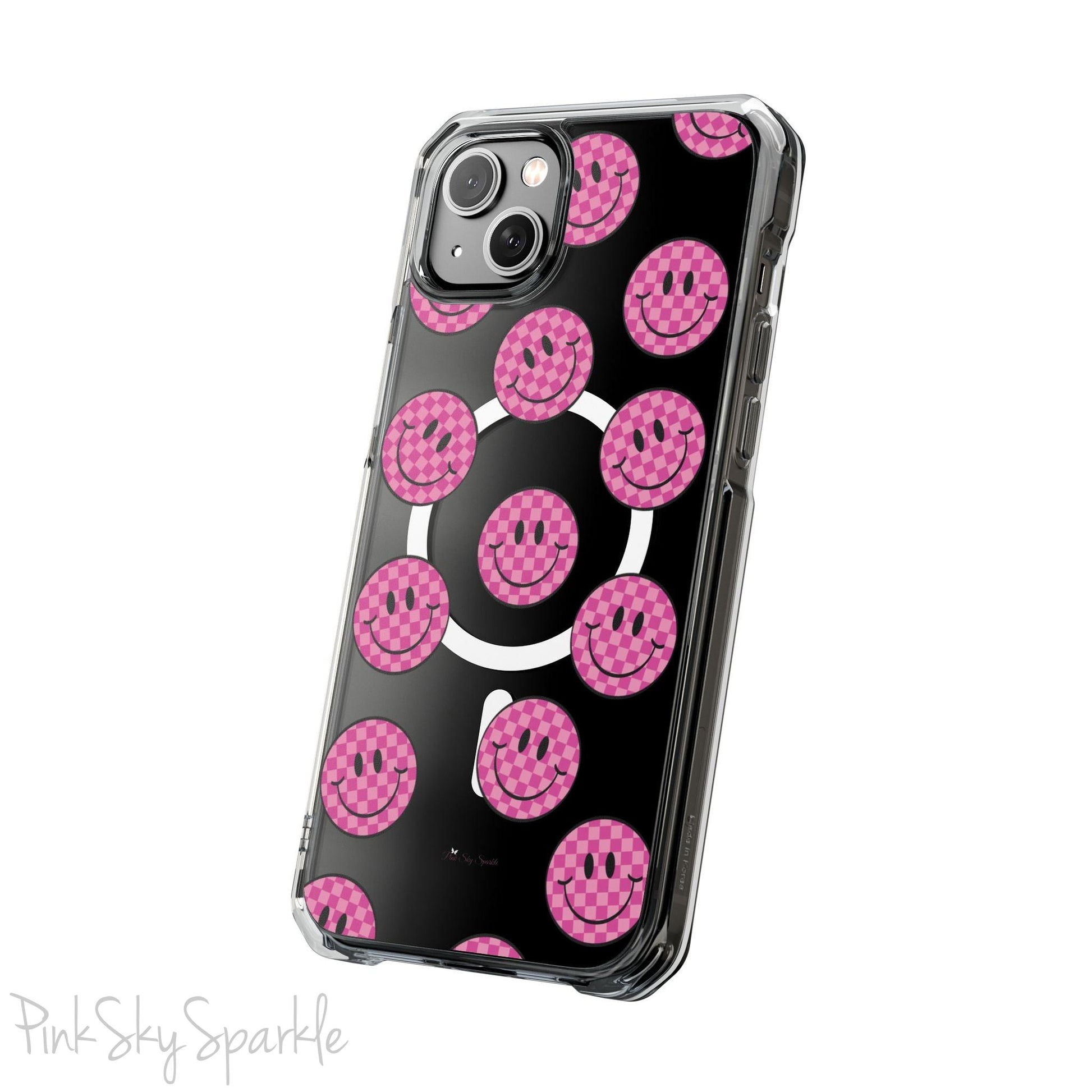 Clear magnetic phone case featuring pink checkered smiley faces on a transparent background, designed for MagSafe® compatibility with air-cushioned bumper corners.