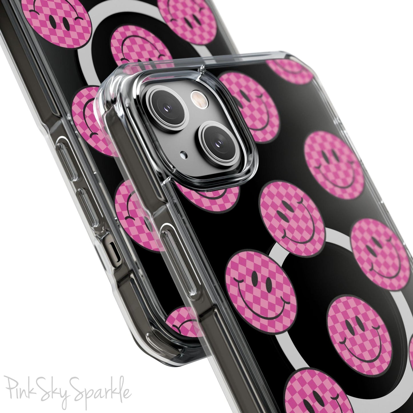 Clear magnetic phone case featuring pink checkered smiley faces on a transparent background, designed for MagSafe® compatibility with air-cushioned bumper corners.