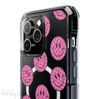 Clear magnetic phone case featuring pink checkered smiley faces on a transparent background, designed for MagSafe® compatibility with air-cushioned bumper corners.