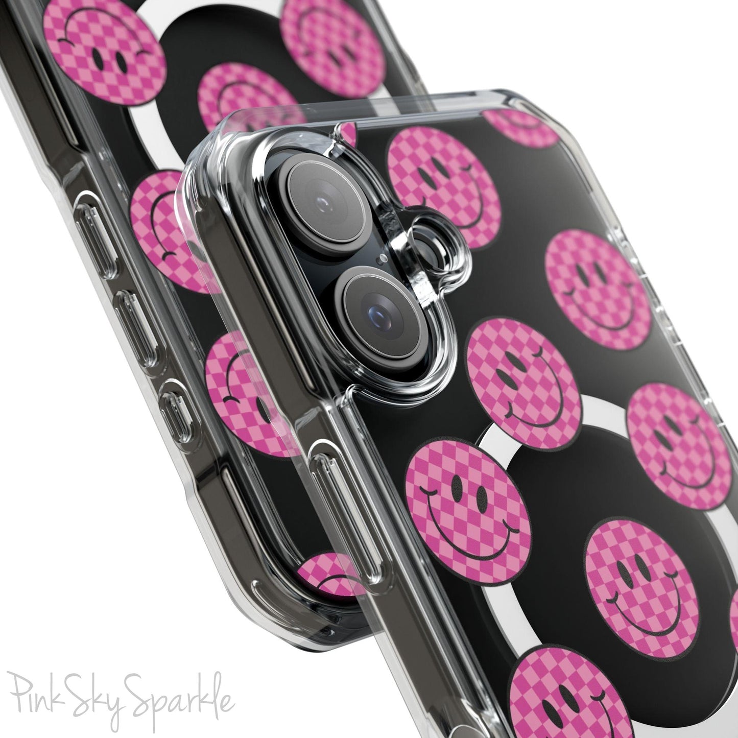 Clear magnetic phone case featuring pink checkered smiley faces on a transparent background, designed for MagSafe® compatibility with air-cushioned bumper corners.