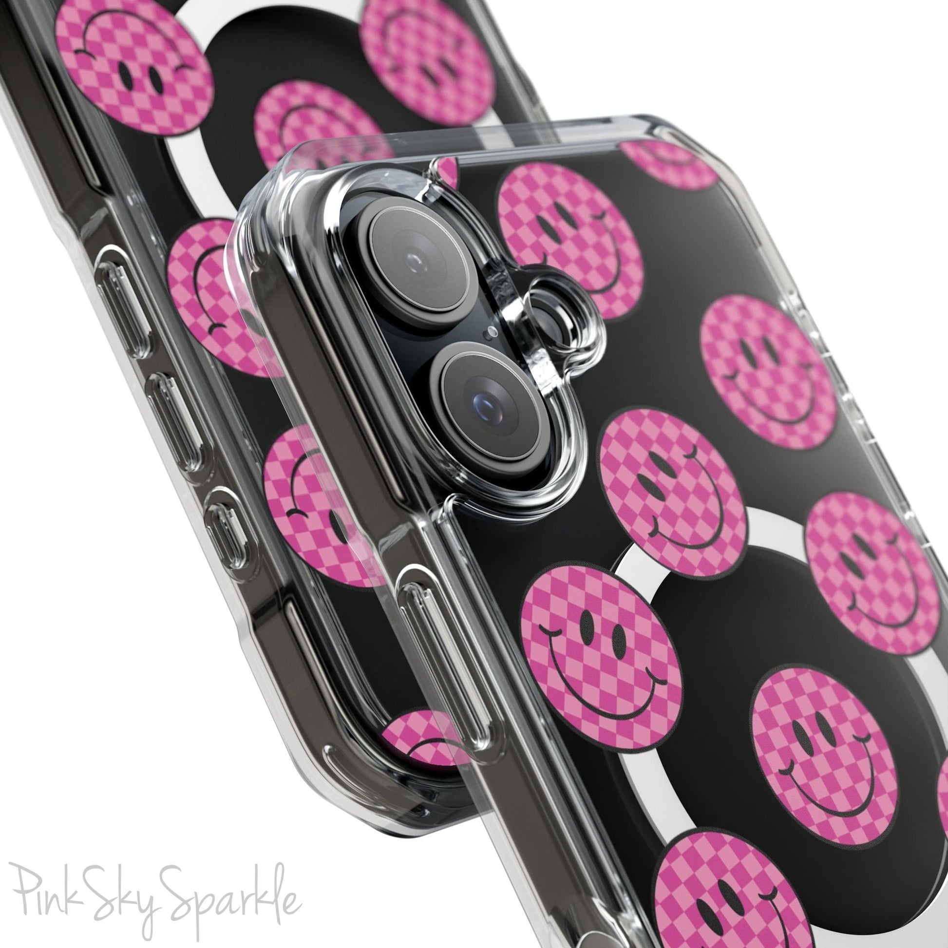 Clear magnetic phone case featuring pink checkered smiley faces on a transparent background, designed for MagSafe® compatibility with air-cushioned bumper corners.