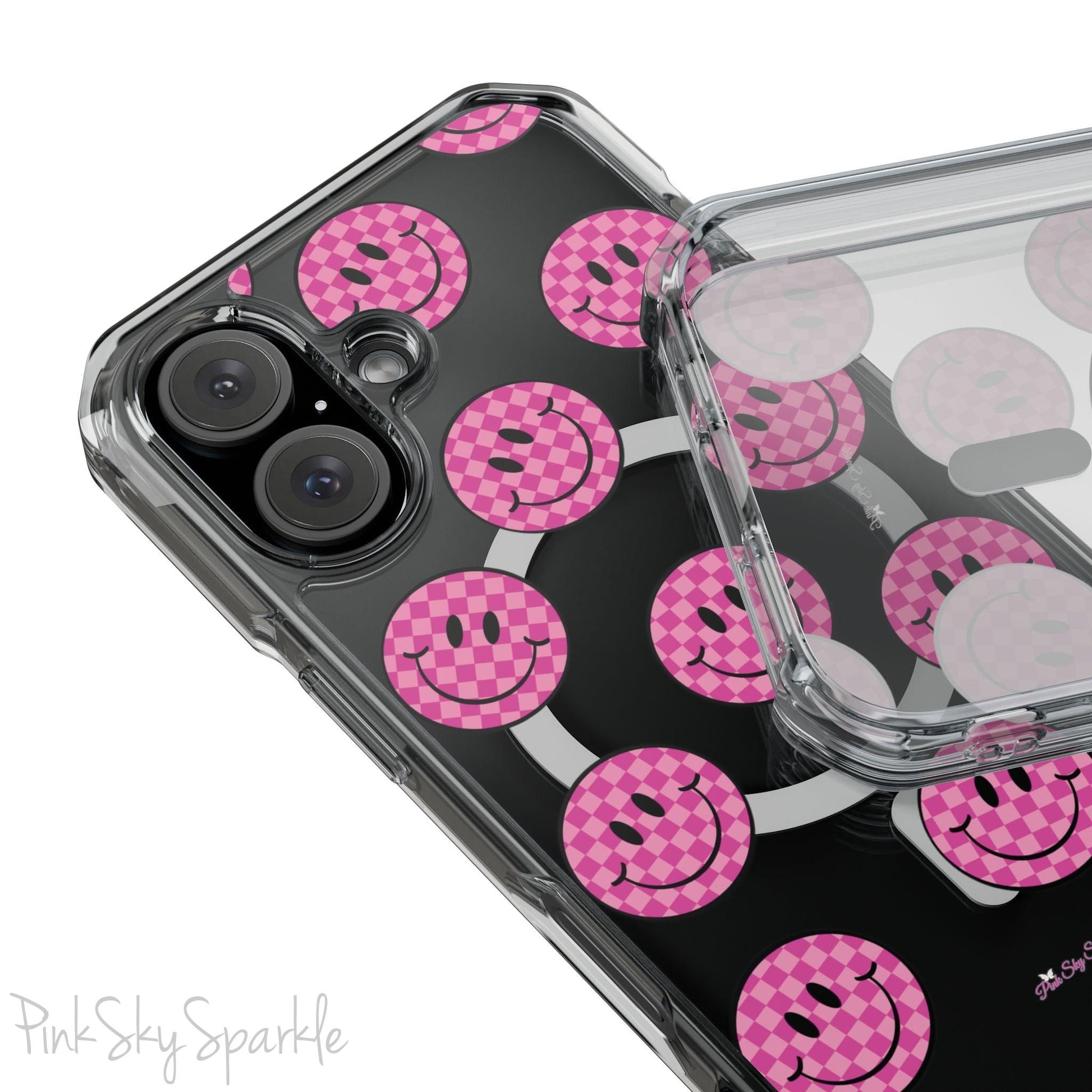 Clear magnetic phone case featuring pink checkered smiley faces on a transparent background, designed for MagSafe® compatibility with air-cushioned bumper corners.