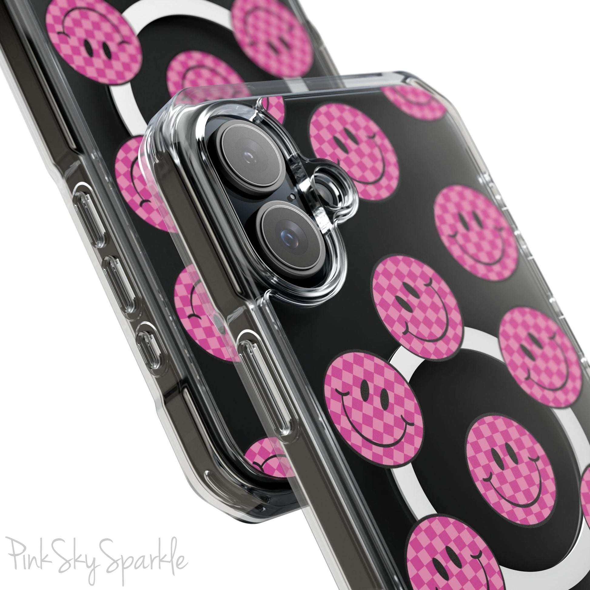 Clear magnetic phone case featuring pink checkered smiley faces on a transparent background, designed for MagSafe® compatibility with air-cushioned bumper corners.