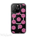 Clear magnetic phone case featuring pink checkered smiley faces on a transparent background, designed for MagSafe® compatibility with air-cushioned bumper corners.