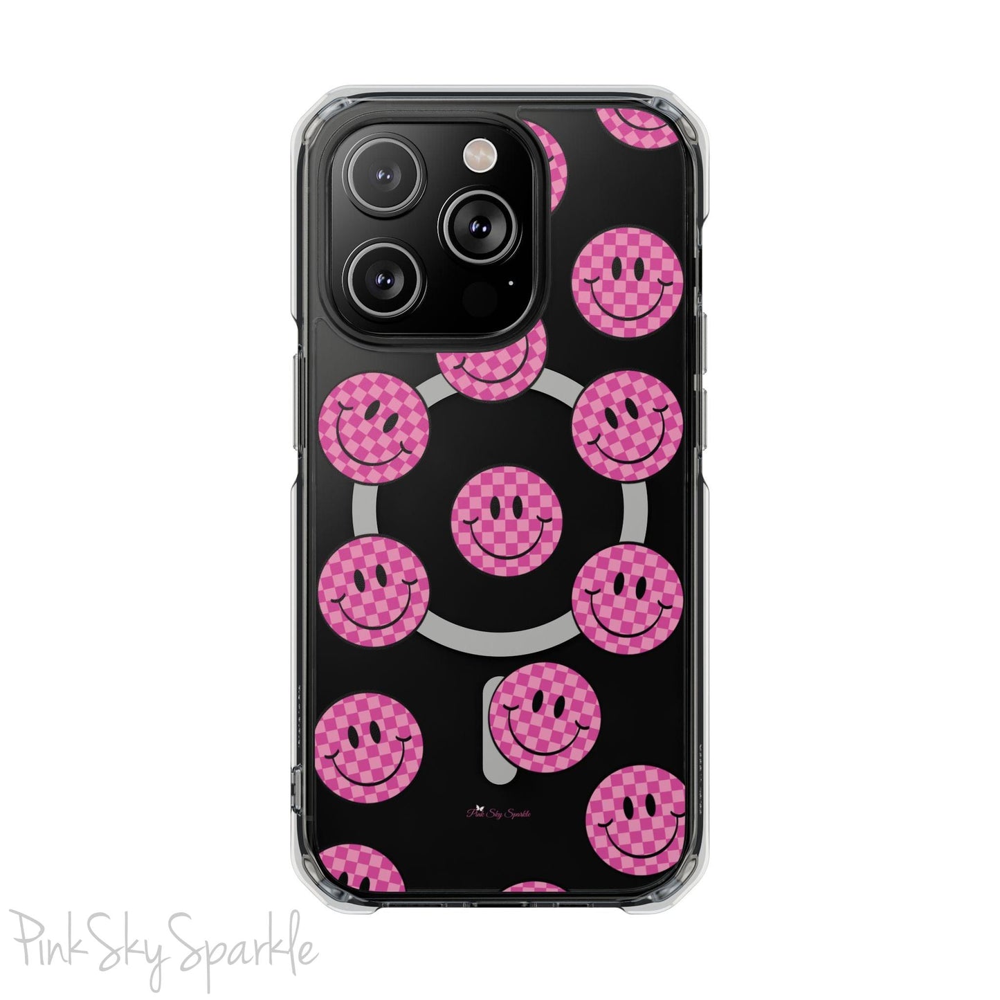 Clear magnetic phone case featuring pink checkered smiley faces on a transparent background, designed for MagSafe® compatibility with air-cushioned bumper corners.