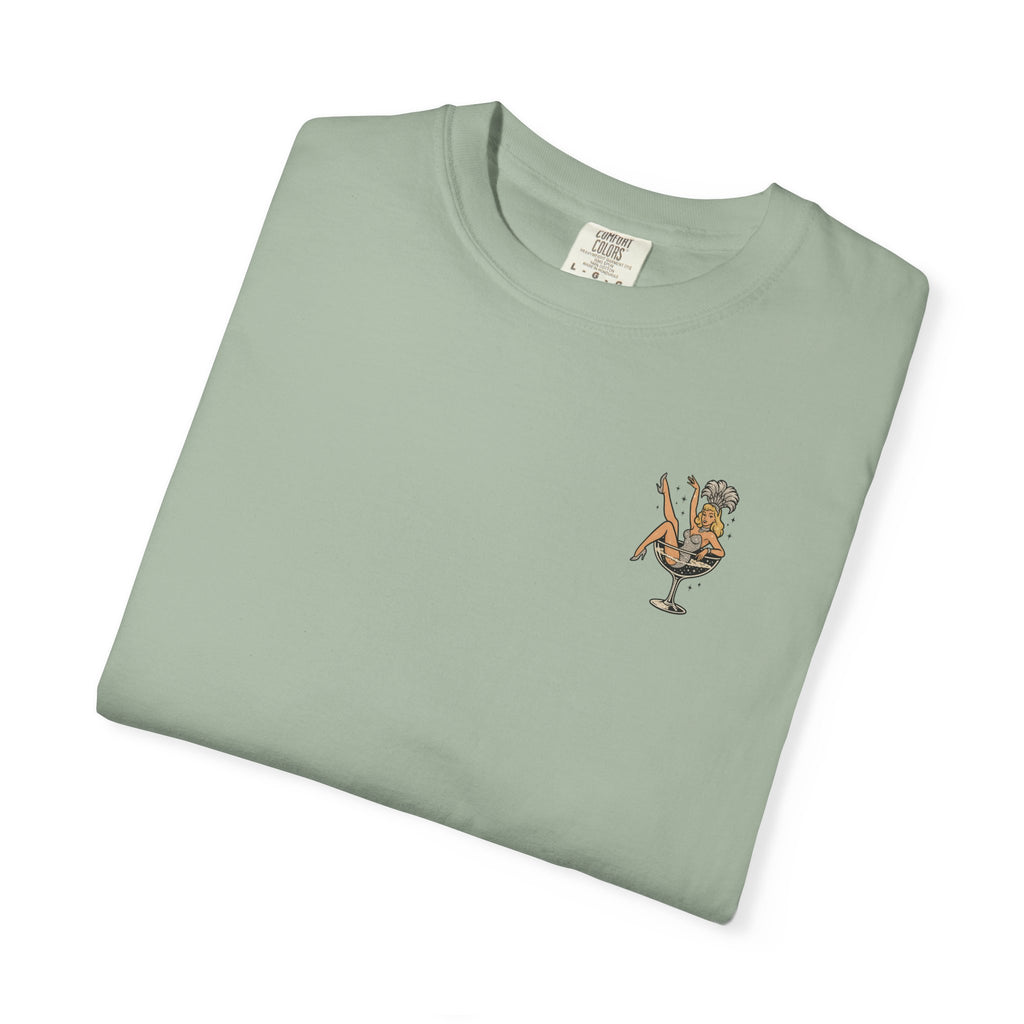 Folded light green t-shirt with a small showgirl graphic on a white background