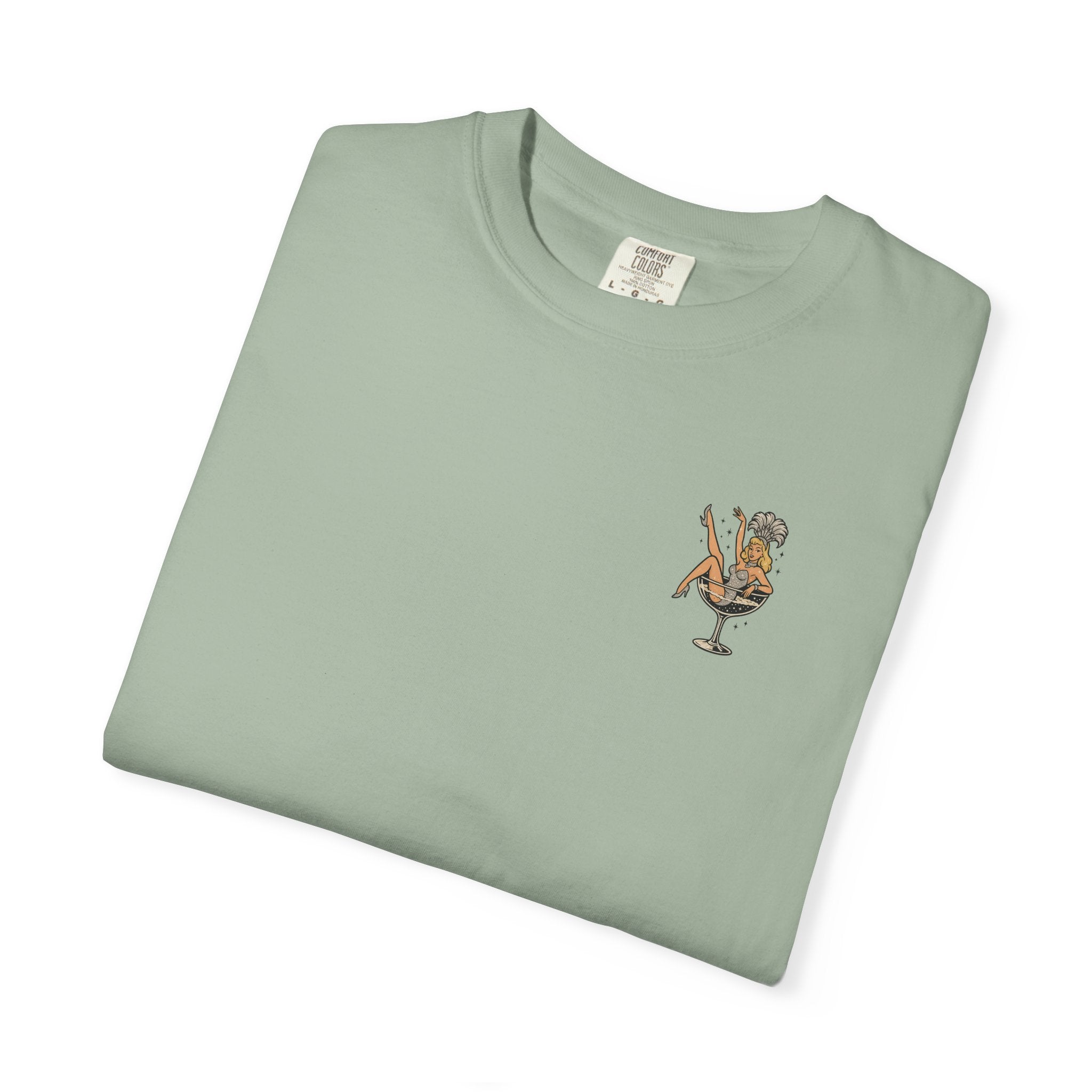 Folded light green t-shirt with a small showgirl graphic on a white background