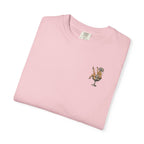 Folded pink t-shirt with a graphic design on a white background