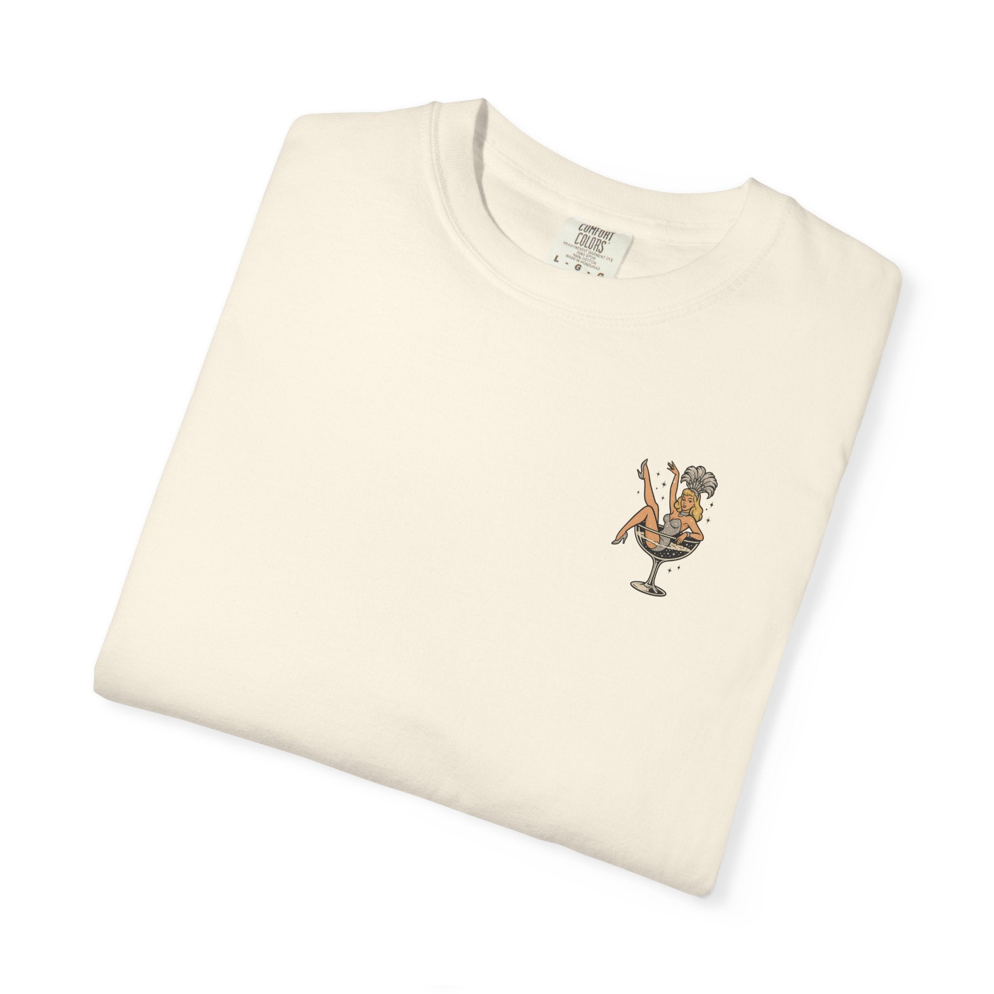 Folded cream-colored t-shirt with a showgirl graphic design on a white background