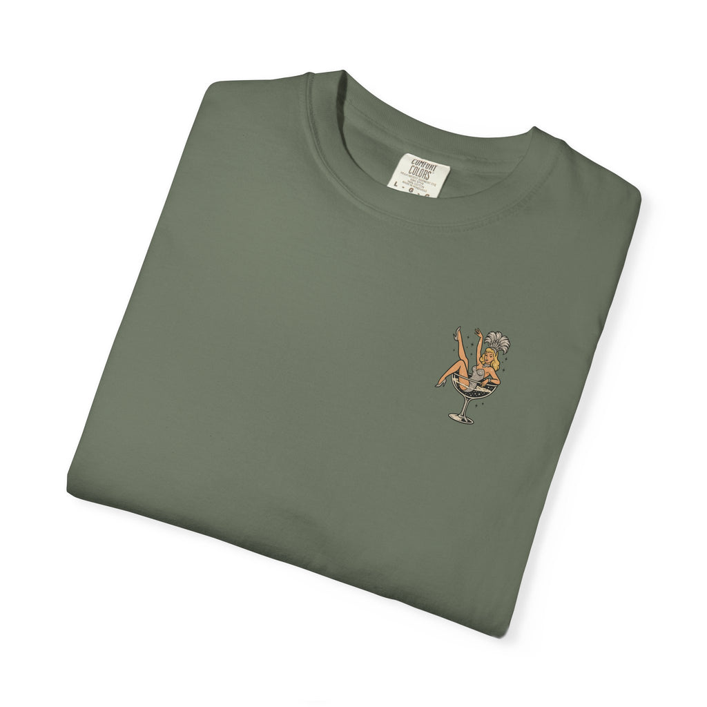 Folded green t-shirt with a small showgirl graphic on a white background