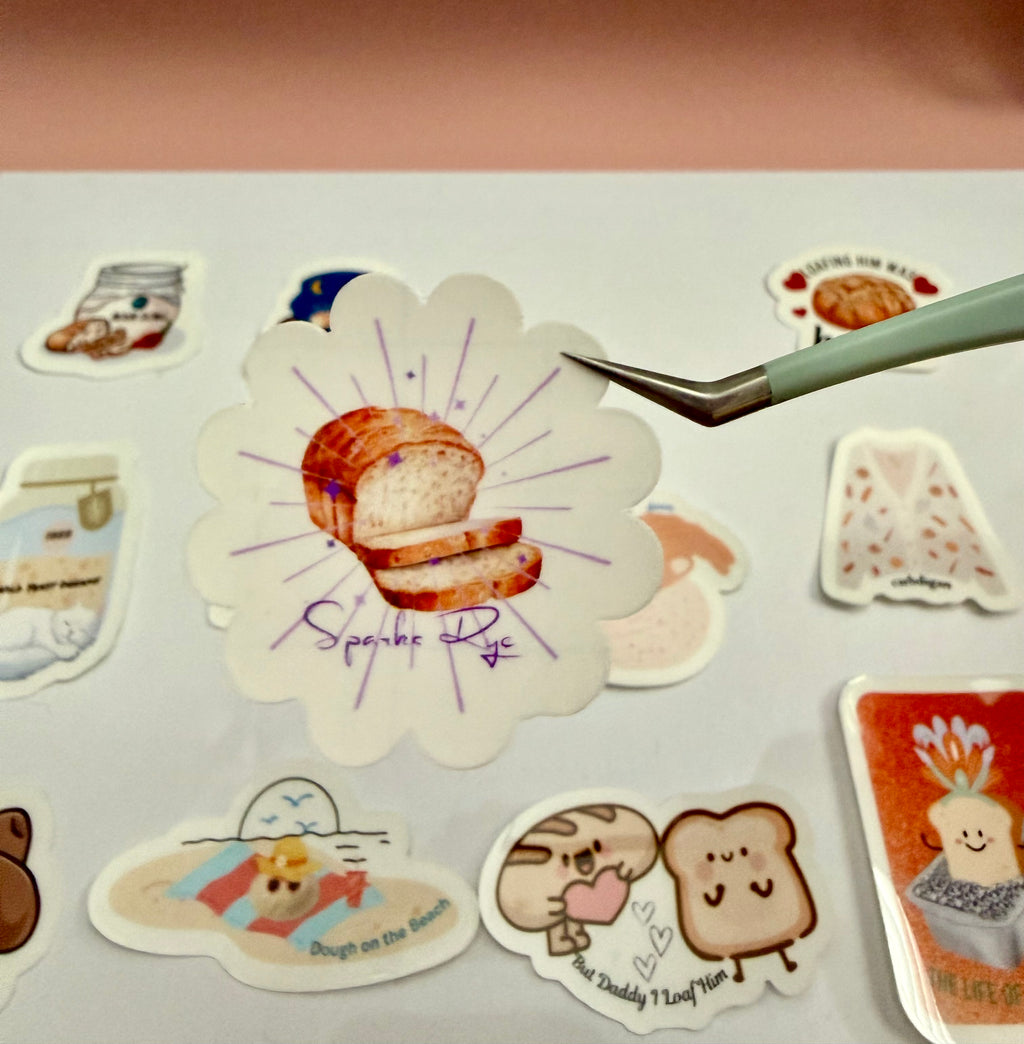 Sticker with loaf of bread and purple sparks that says 'Sparks Rye' in purple front. 