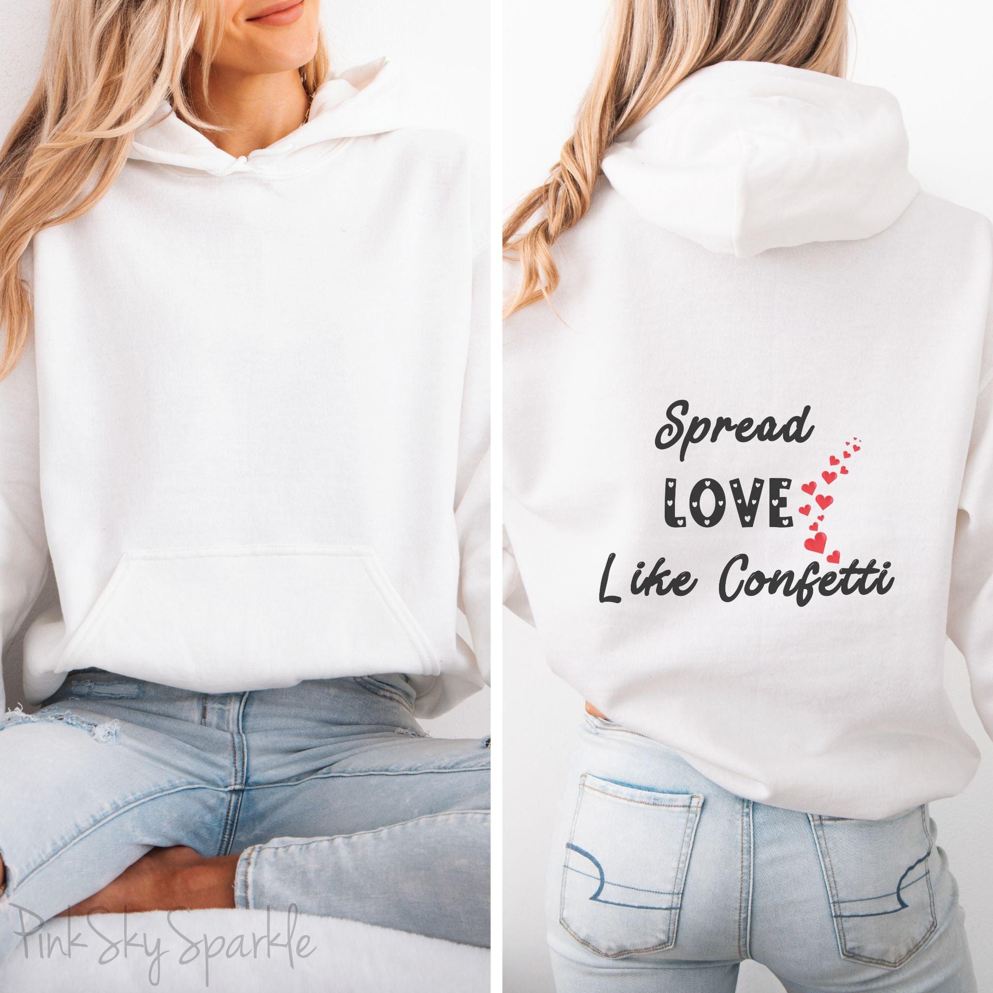 Cozy sweatshirt with the uplifting message “Spread Love Like Confetti” in bold, stylish font.