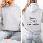 Cozy sweatshirt with the uplifting message “Spread Love Like Confetti” in bold, stylish font.