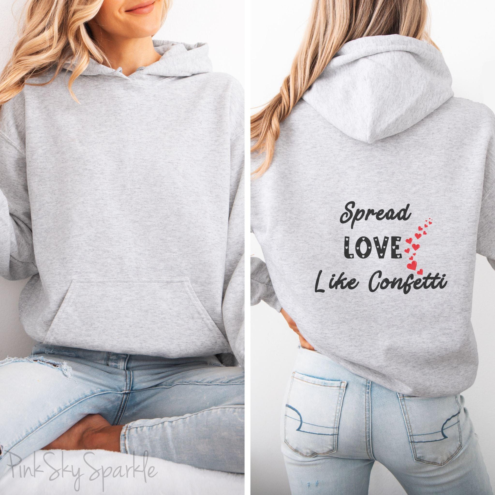 Cozy sweatshirt with the uplifting message “Spread Love Like Confetti” in bold, stylish font.