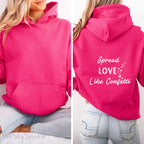 Cozy sweatshirt with the uplifting message “Spread Love Like Confetti” in bold, stylish font.