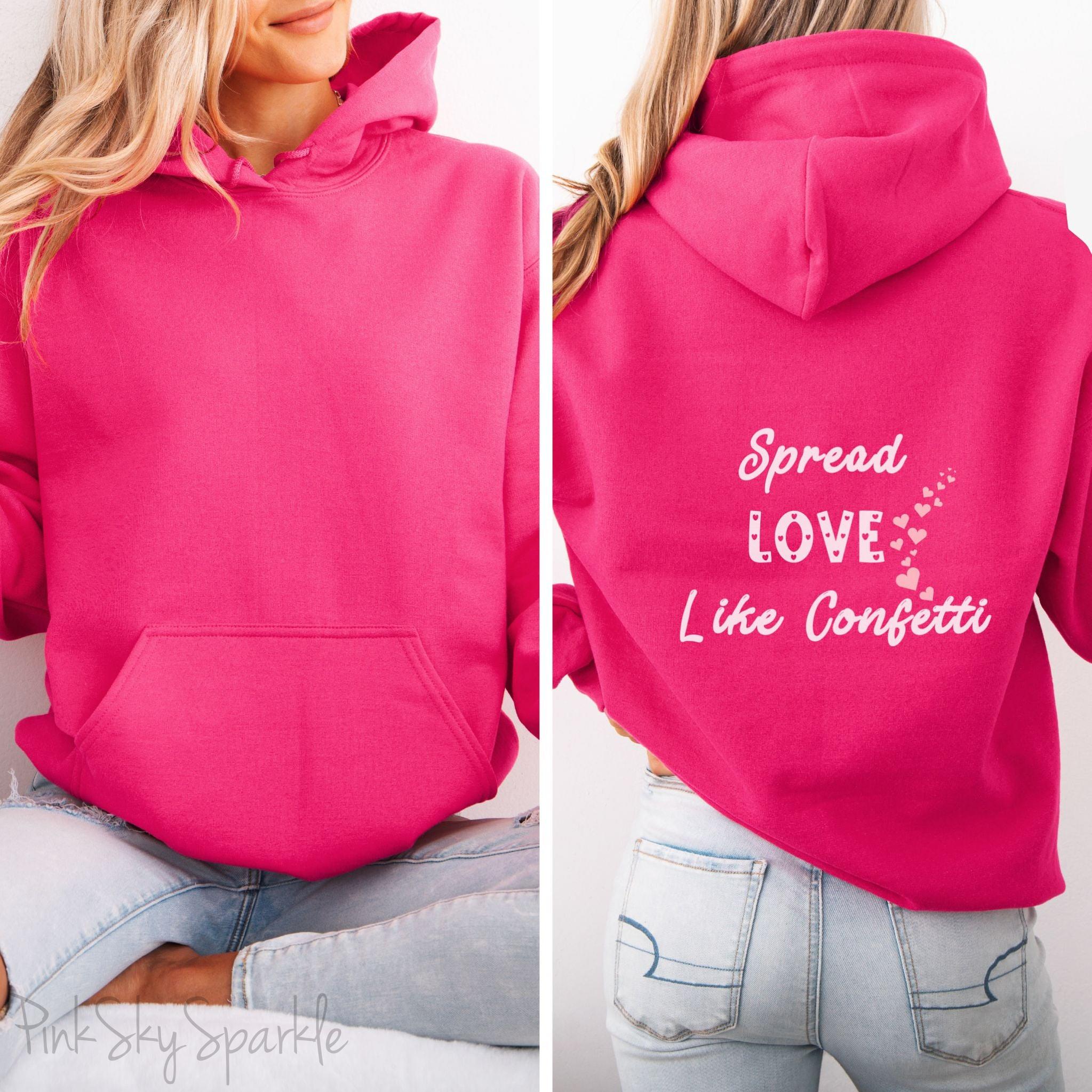 Cozy sweatshirt with the uplifting message “Spread Love Like Confetti” in bold, stylish font.