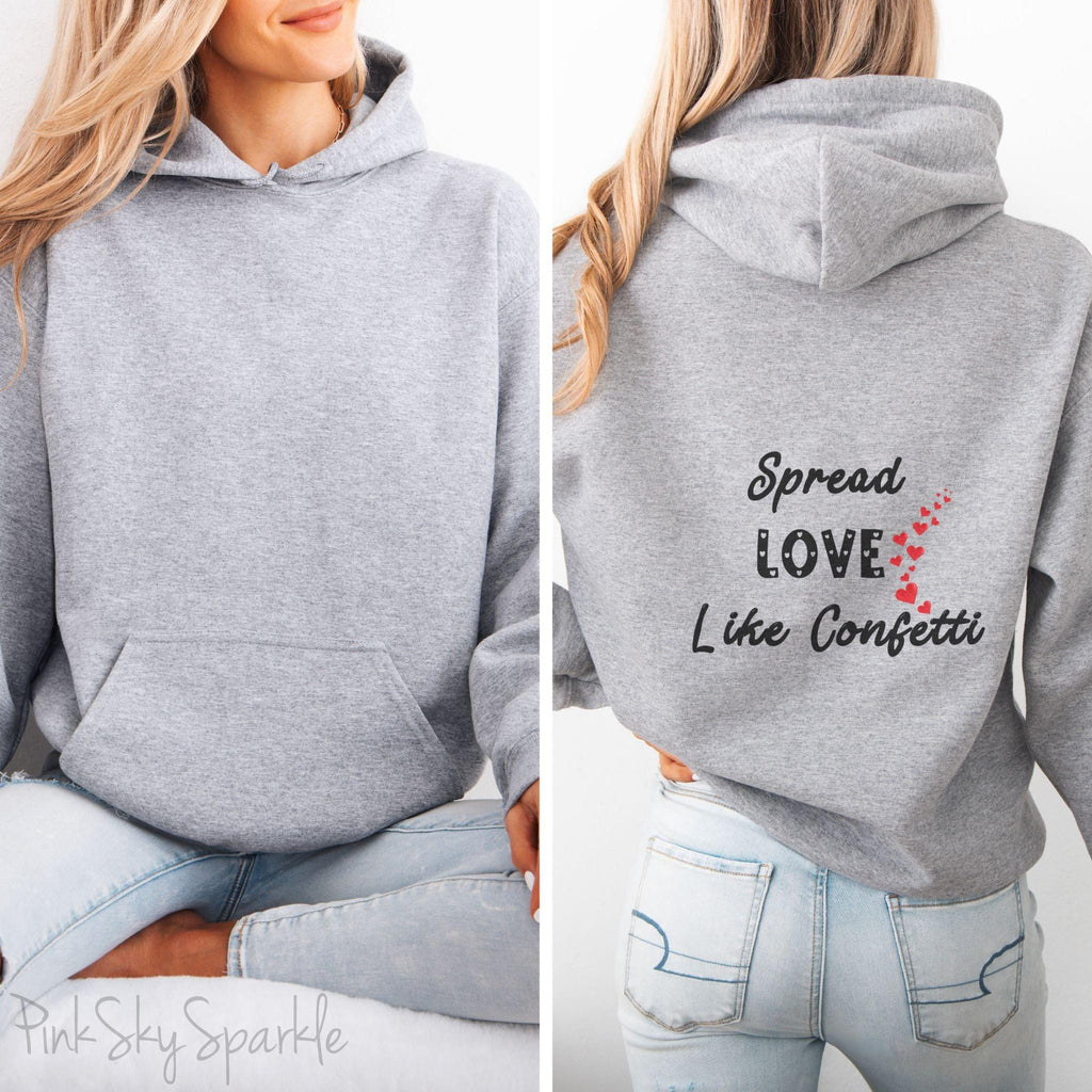Cozy sweatshirt with the uplifting message “Spread Love Like Confetti” in bold, stylish font.