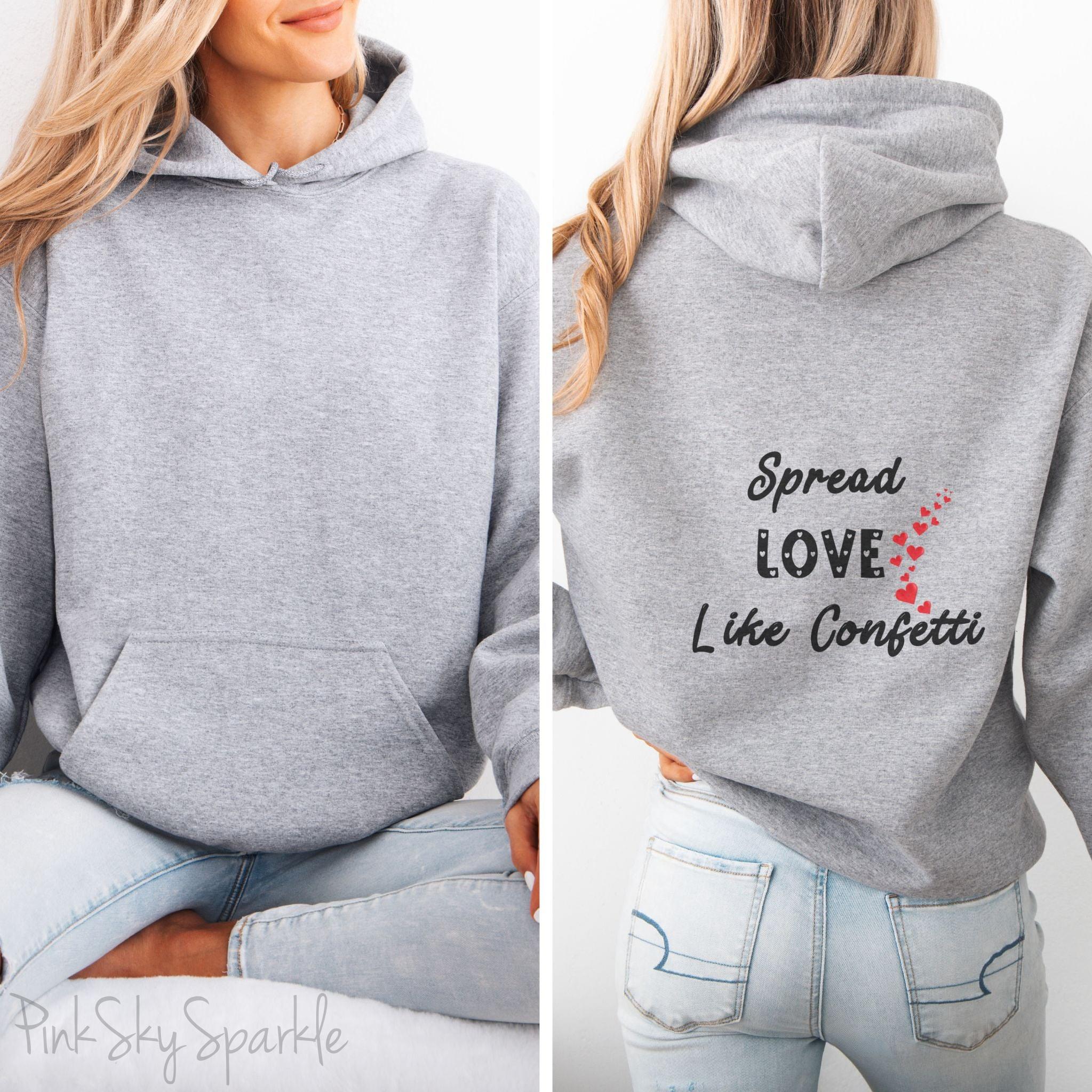 Cozy sweatshirt with the uplifting message “Spread Love Like Confetti” in bold, stylish font.