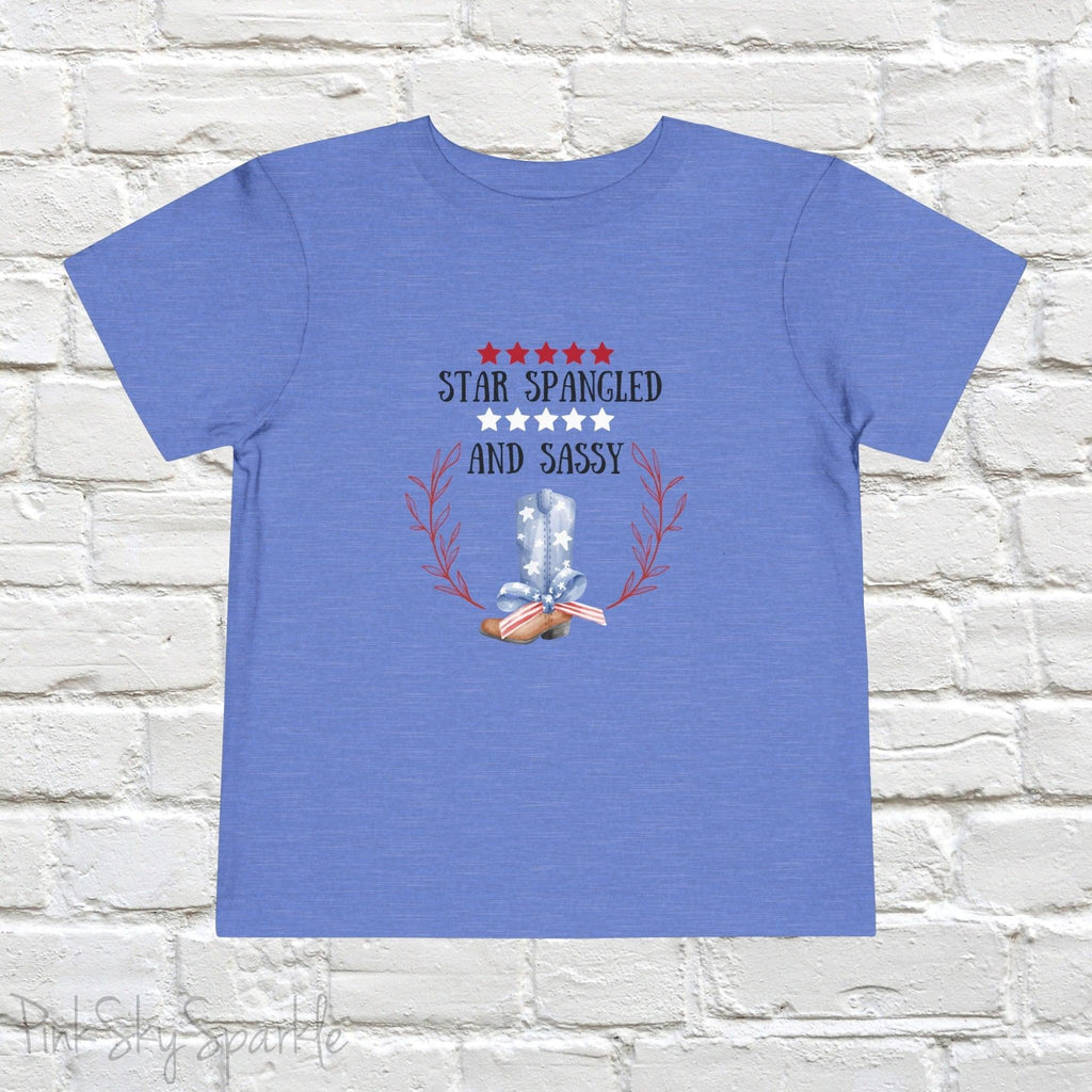 Dress your little one in patriotic style with our adorable toddler t-shirt, perfect for the 4th of July! This charming tee features the playful phrase "Star Spangled and Sassy" alongside a cute graphic of a red, white, and blue cowgirl boot adorned with a bow.