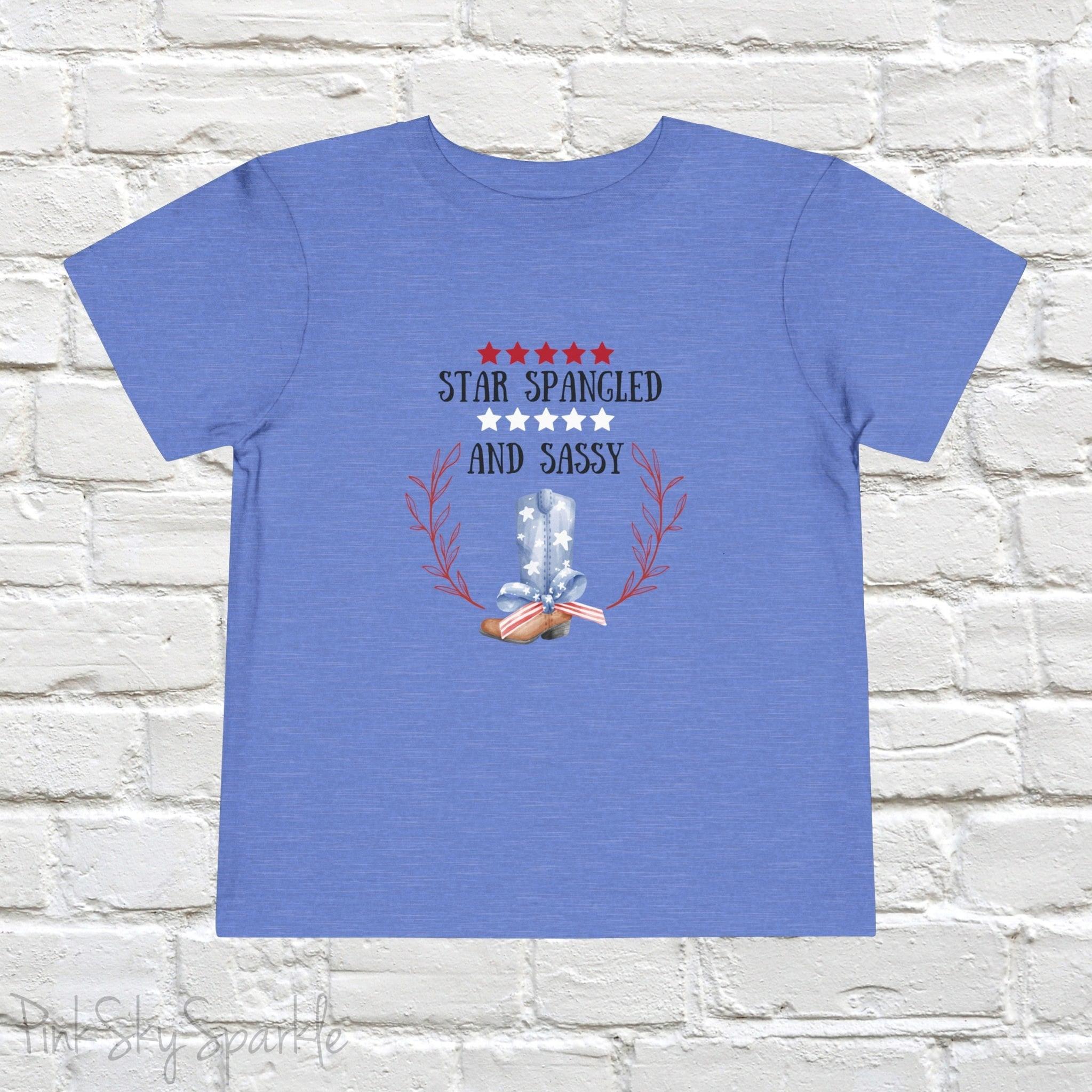 Dress your little one in patriotic style with our adorable toddler t-shirt, perfect for the 4th of July! This charming tee features the playful phrase "Star Spangled and Sassy" alongside a cute graphic of a red, white, and blue cowgirl boot adorned with a bow.