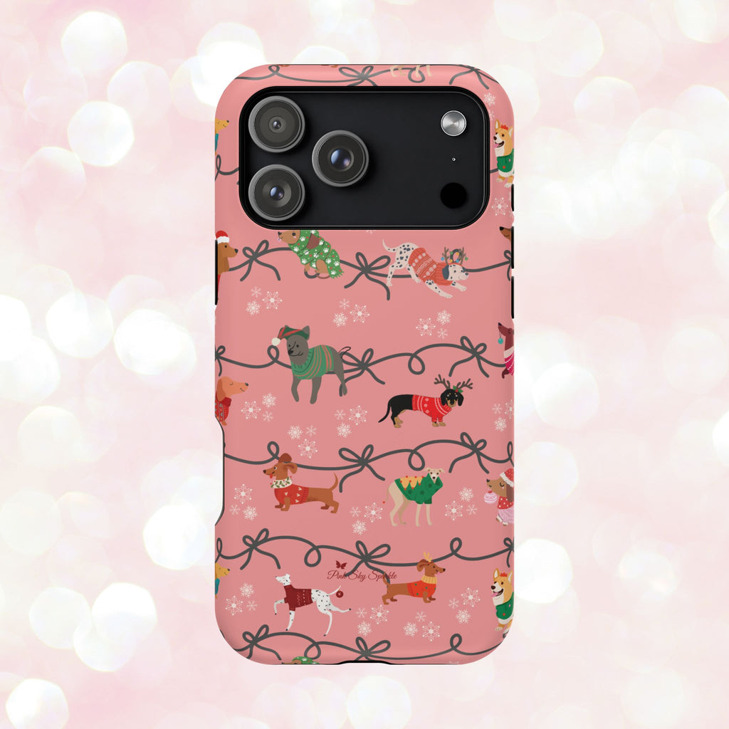 iPhone case with holiday dogs in sweaters on pink background.