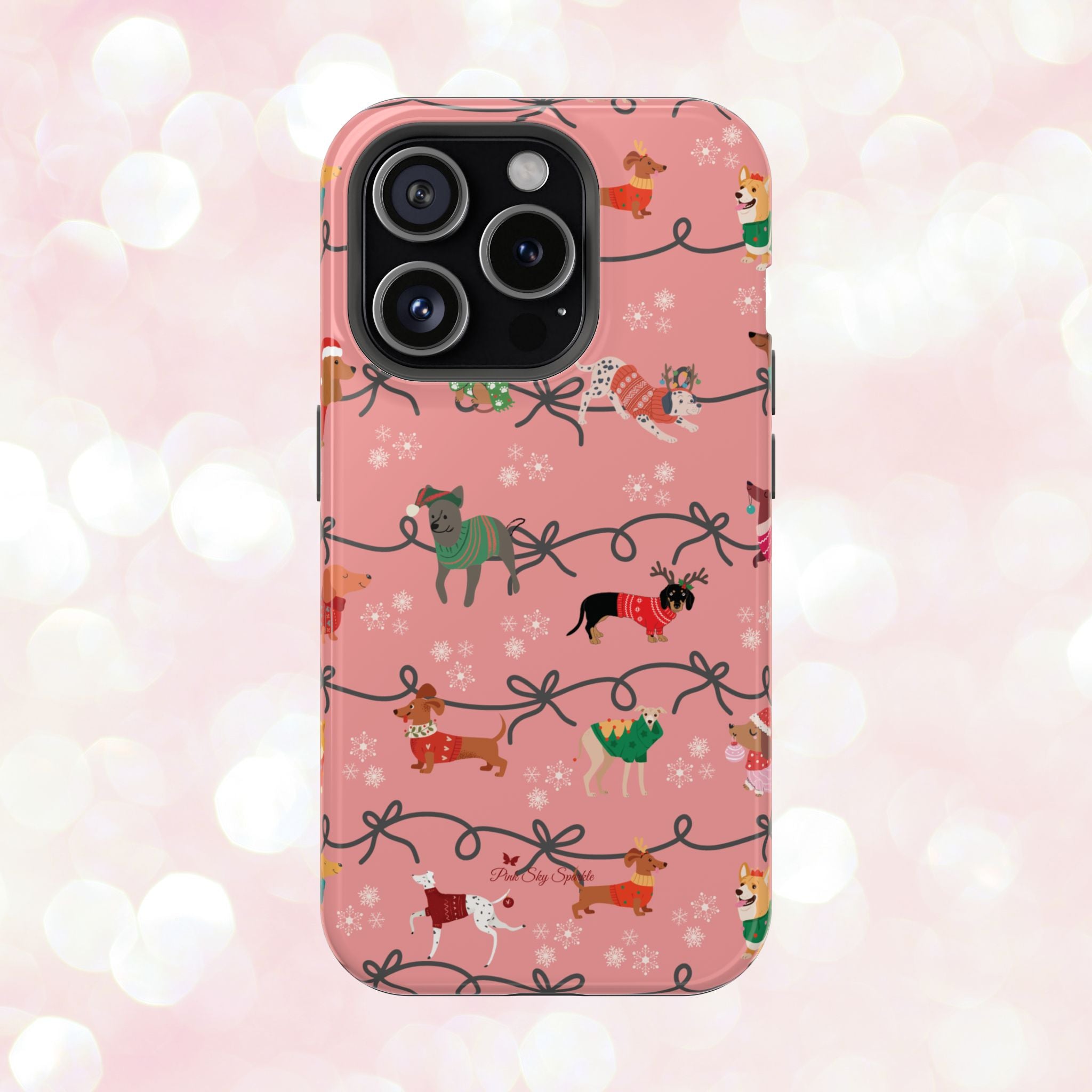 iPhone case with holiday dogs in sweaters on pink background.