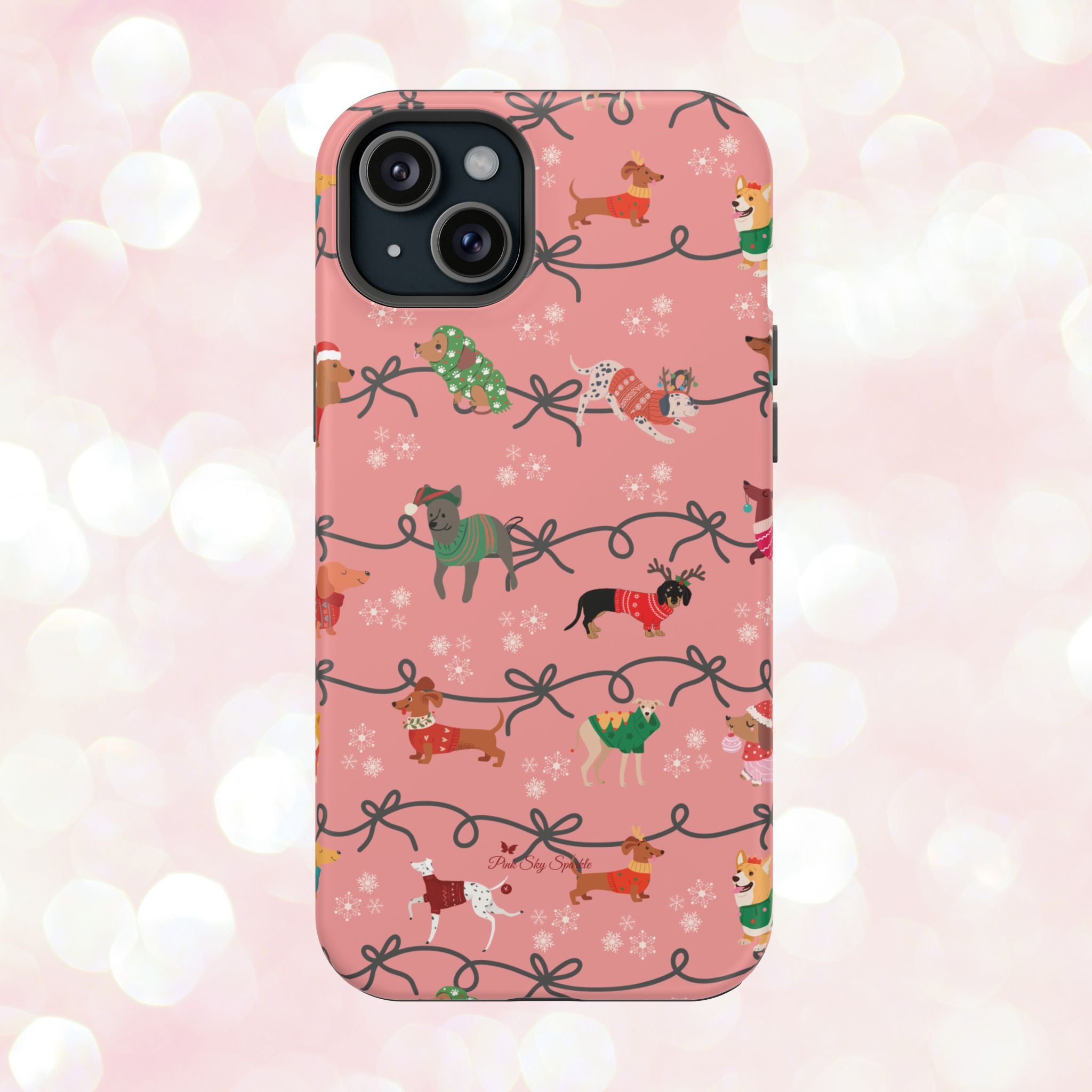 iPhone case with holiday dogs in sweaters on pink background.