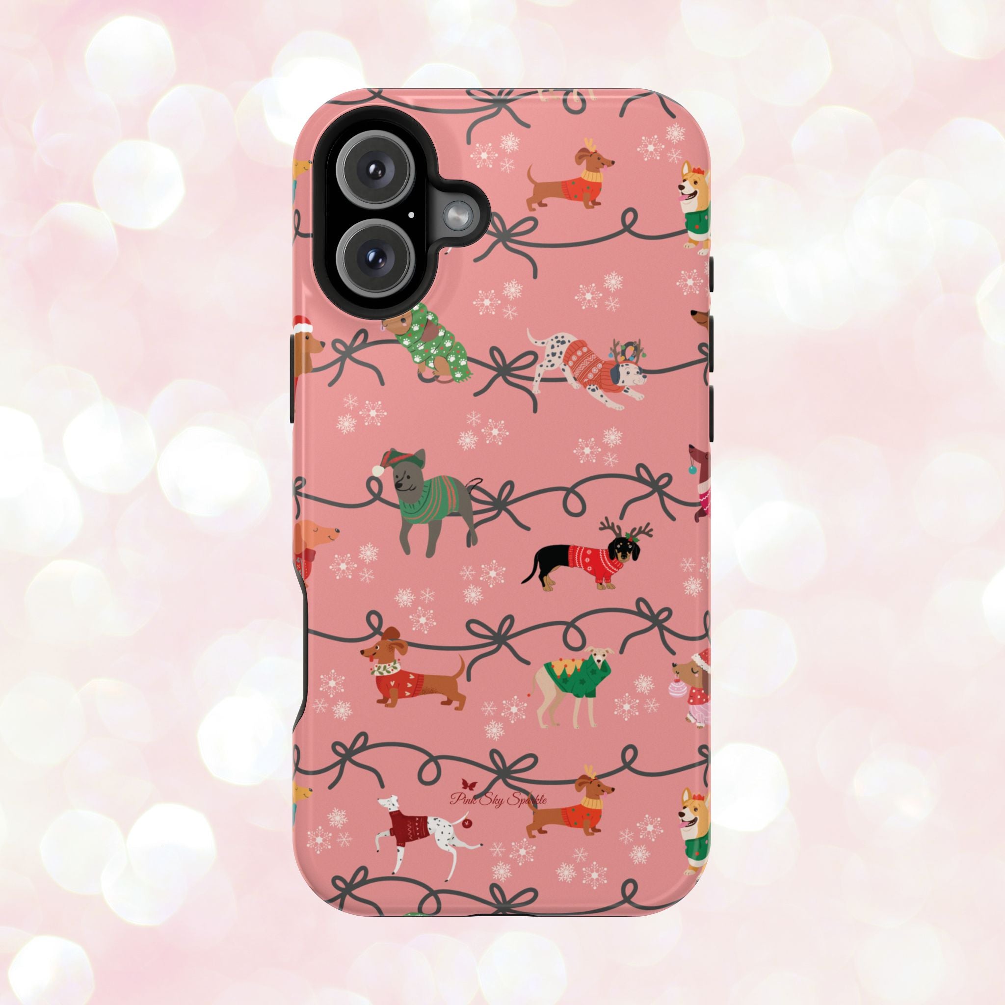iPhone case with holiday dogs in sweaters on pink background.