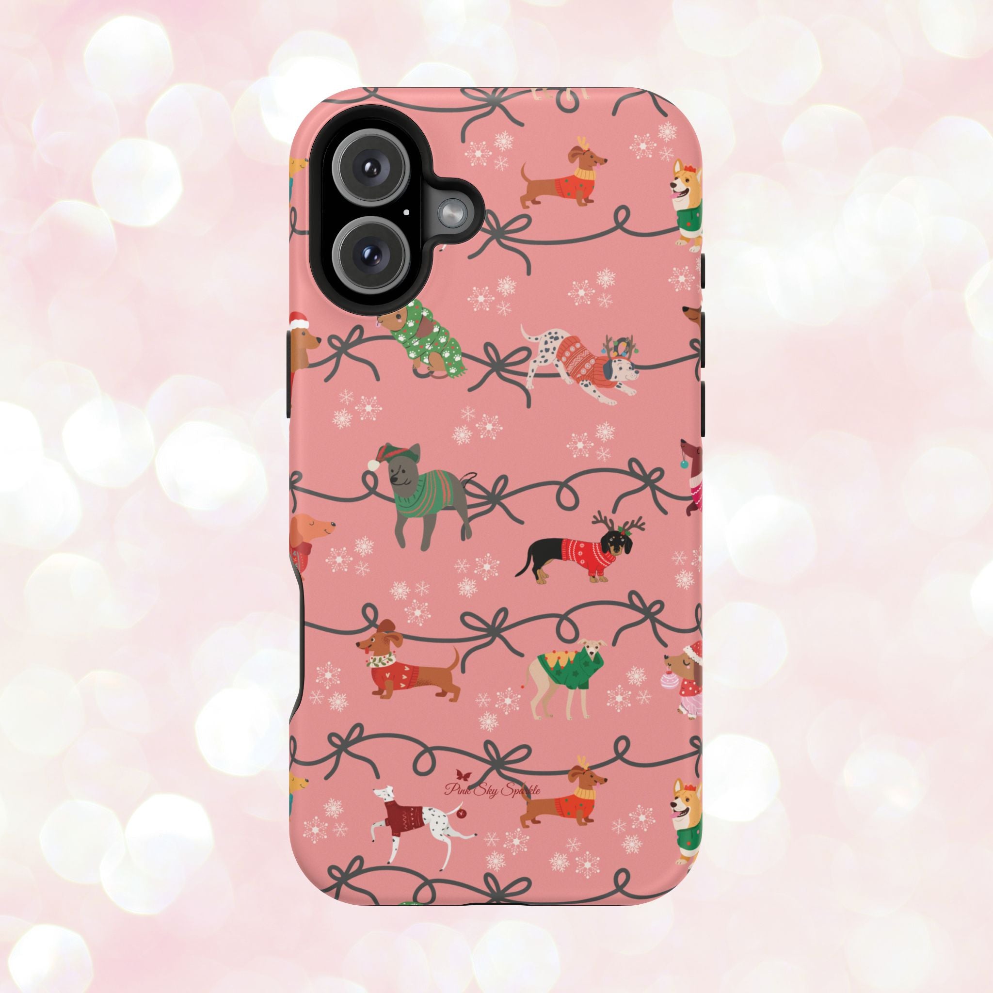 iPhone case with holiday dogs in sweaters on pink background.