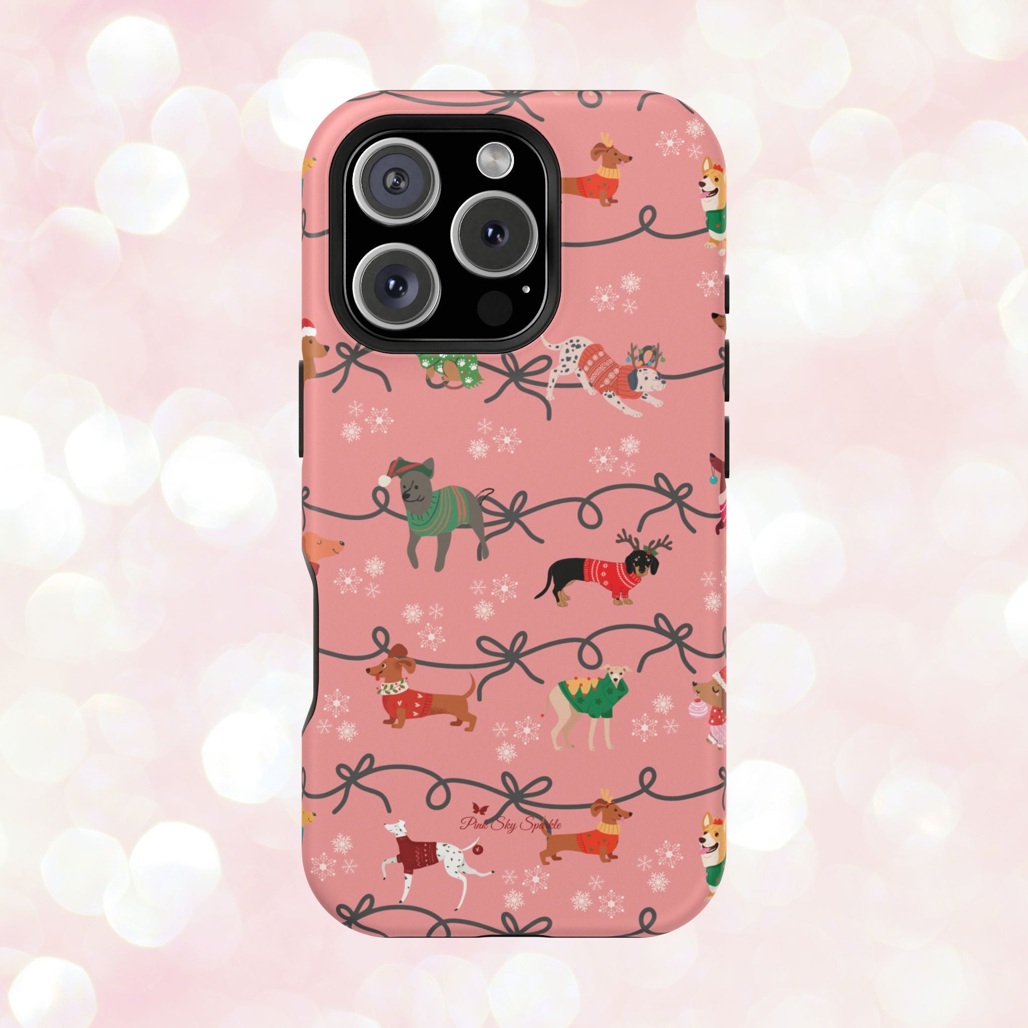 iPhone case with holiday dogs in sweaters on pink background.