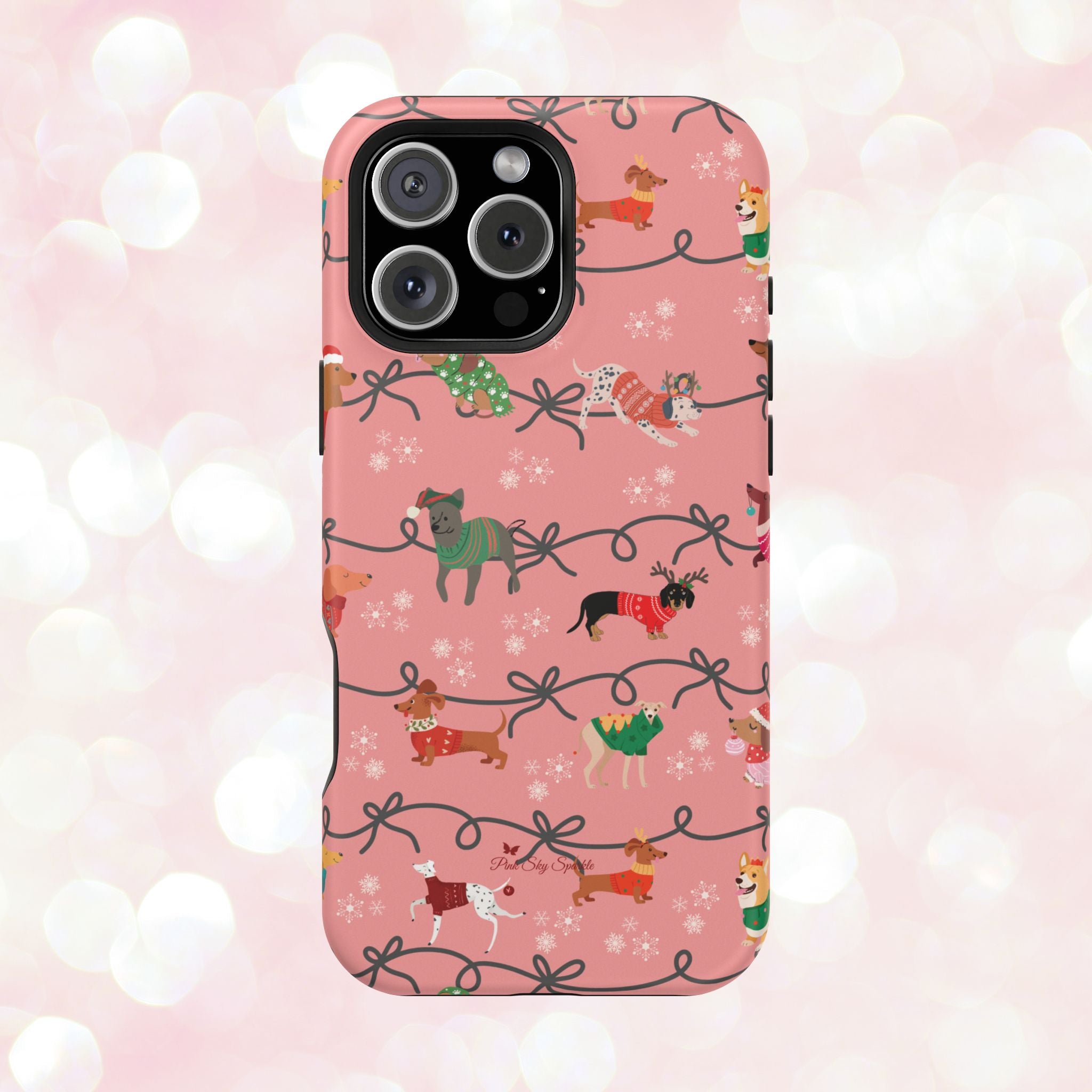 iPhone case with holiday dogs in sweaters on pink background.