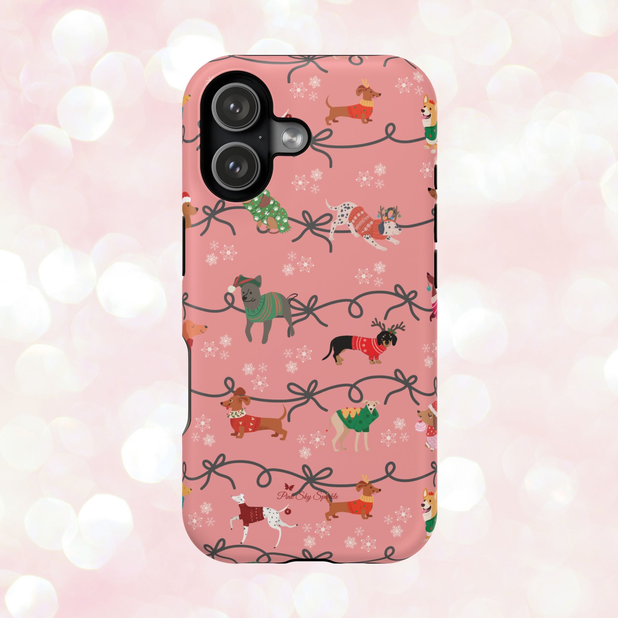 iPhone case with holiday dogs in sweaters on pink background.