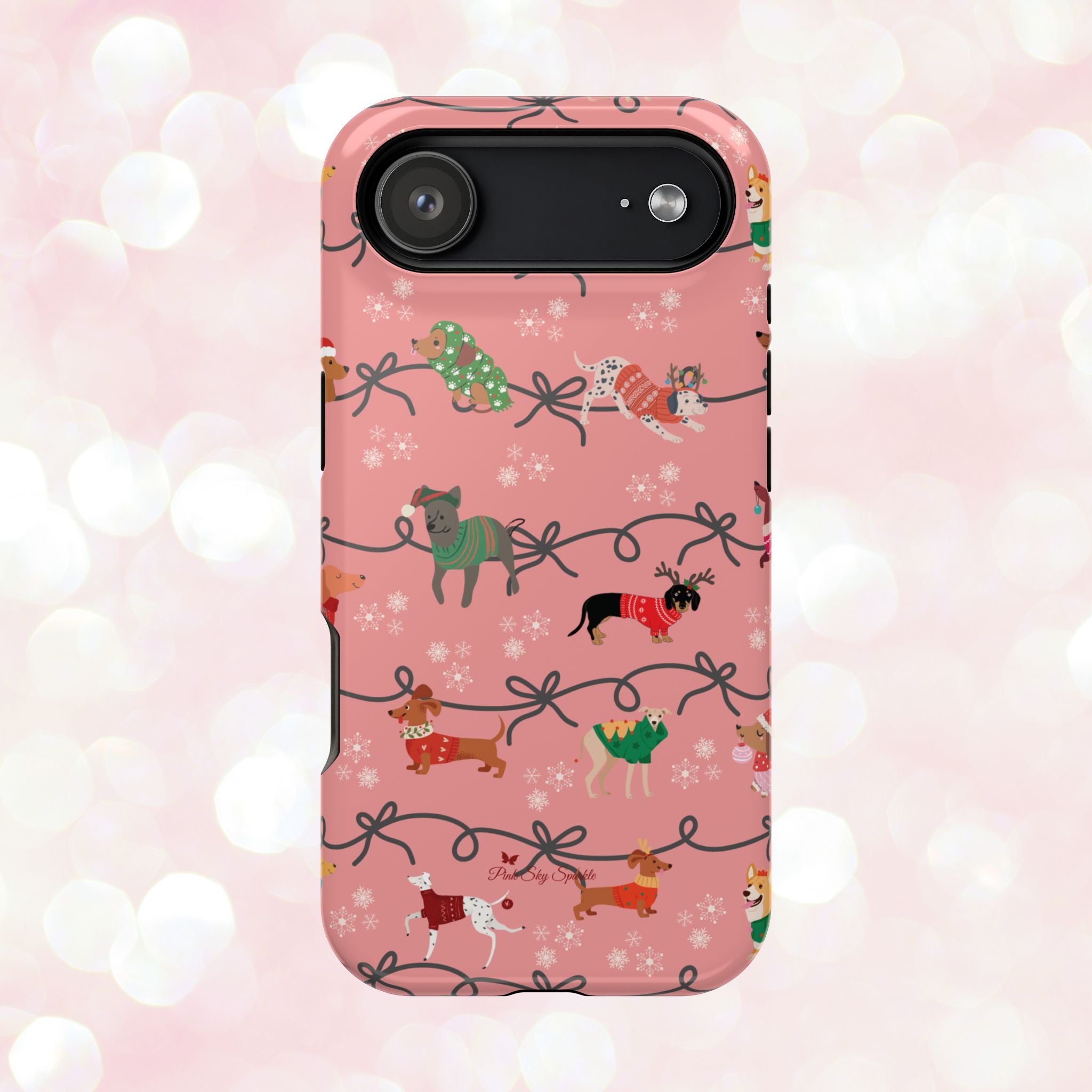 iPhone case with holiday dogs in sweaters on pink background.