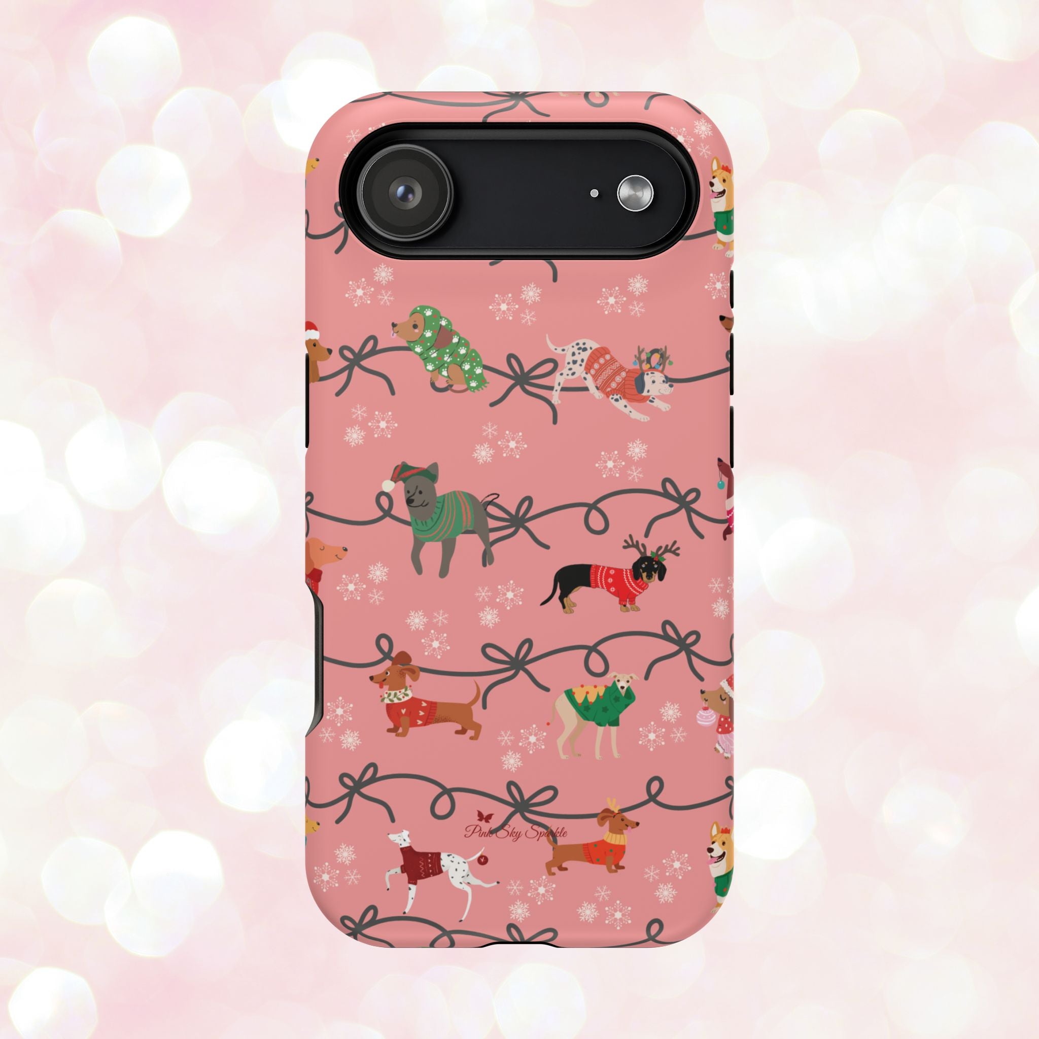 iPhone case with holiday dogs in sweaters on pink background.