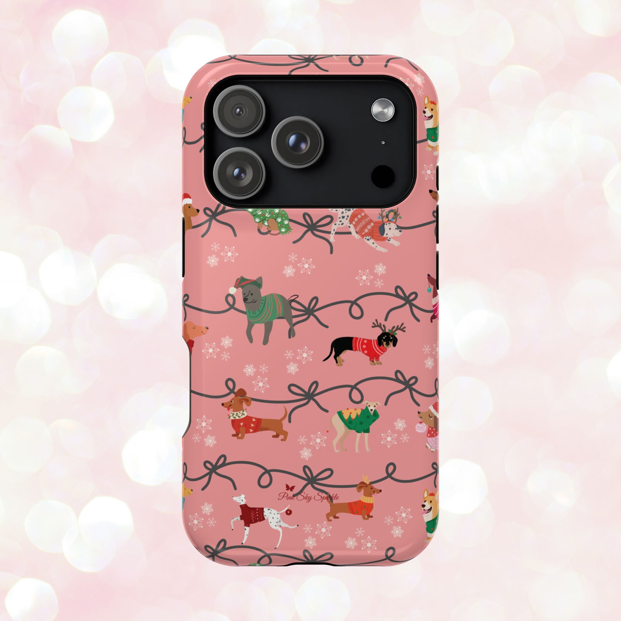 iPhone case with holiday dogs in sweaters on pink background.