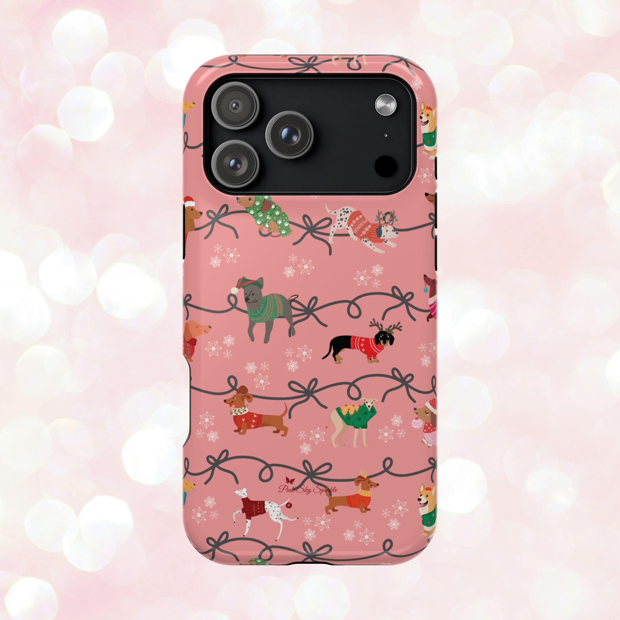 iPhone case with holiday dogs in sweaters on pink background.