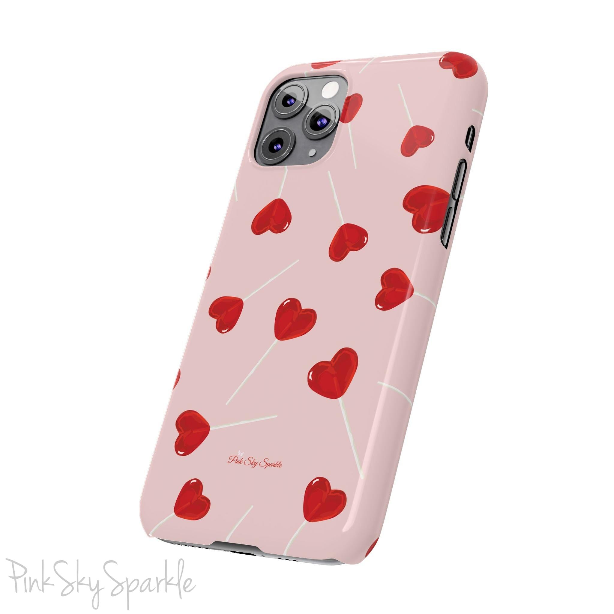 Pink phone case with red heart-shaped lollipop designs, perfect for Valentine’s Day or a playful aesthetic.