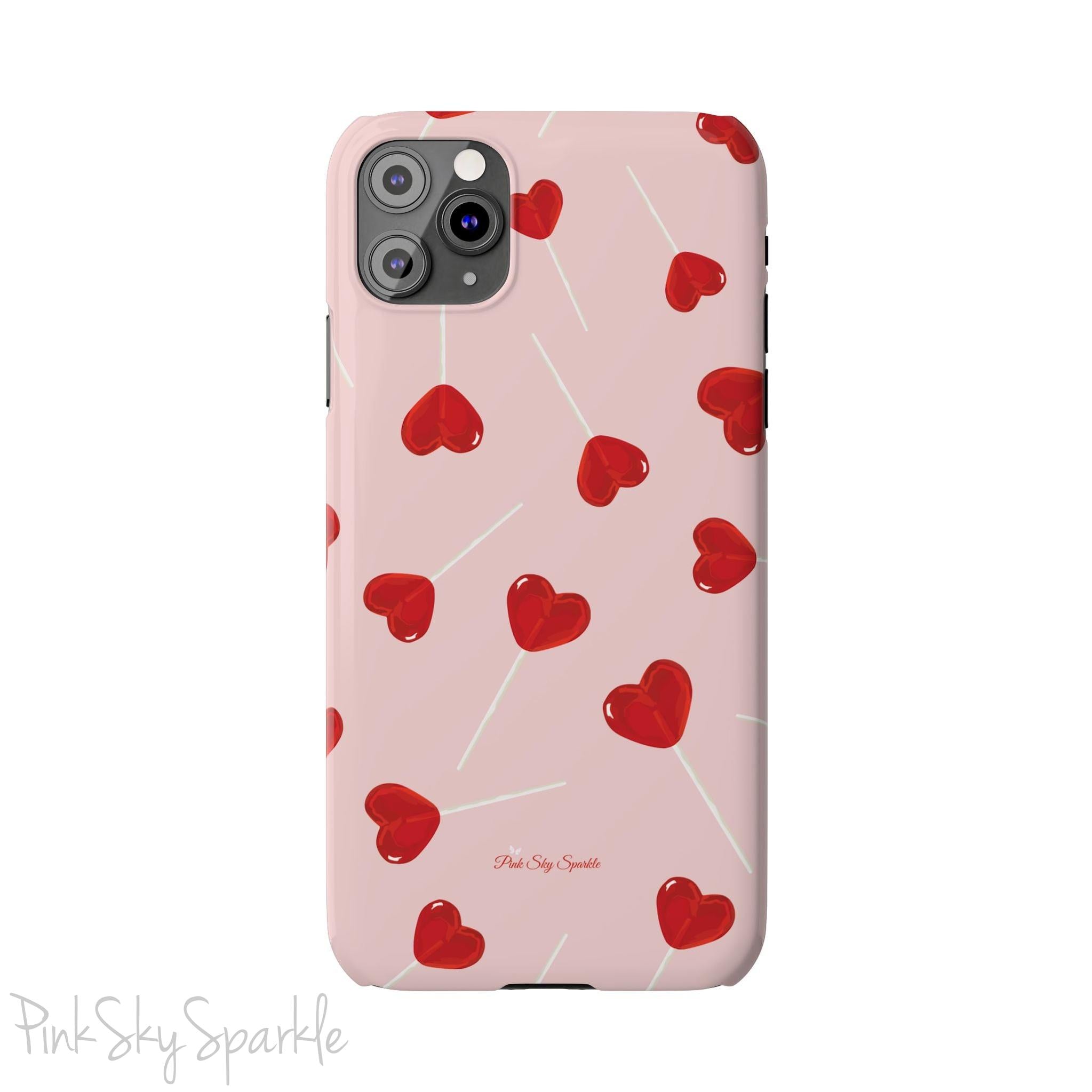 Pink phone case with red heart-shaped lollipop designs, perfect for Valentine’s Day or a playful aesthetic.