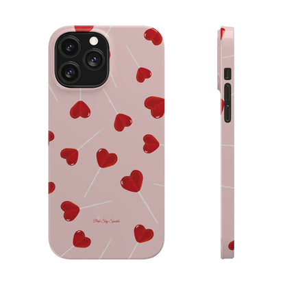 Pink phone case with red heart-shaped lollipop designs, perfect for Valentine’s Day or a playful aesthetic.