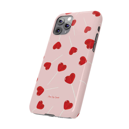 Pink phone case with red heart-shaped lollipop designs, perfect for Valentine’s Day or a playful aesthetic.