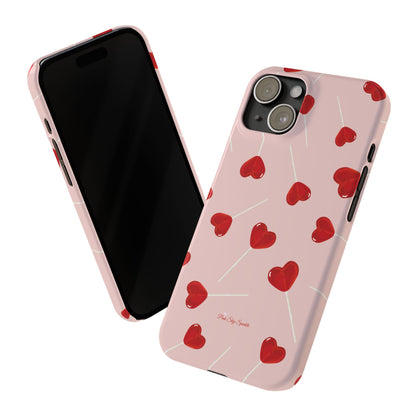 Pink phone case with red heart-shaped lollipop designs, perfect for Valentine’s Day or a playful aesthetic.