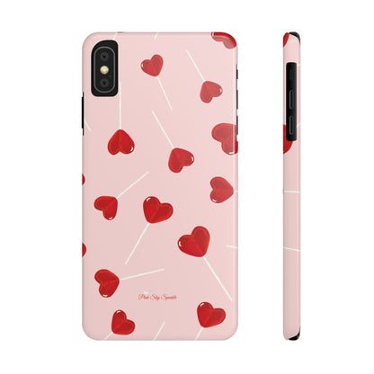 Pink phone case with red heart-shaped lollipop designs, perfect for Valentine’s Day or a playful aesthetic.