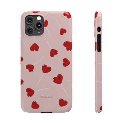 Pink phone case with red heart-shaped lollipop designs, perfect for Valentine’s Day or a playful aesthetic.