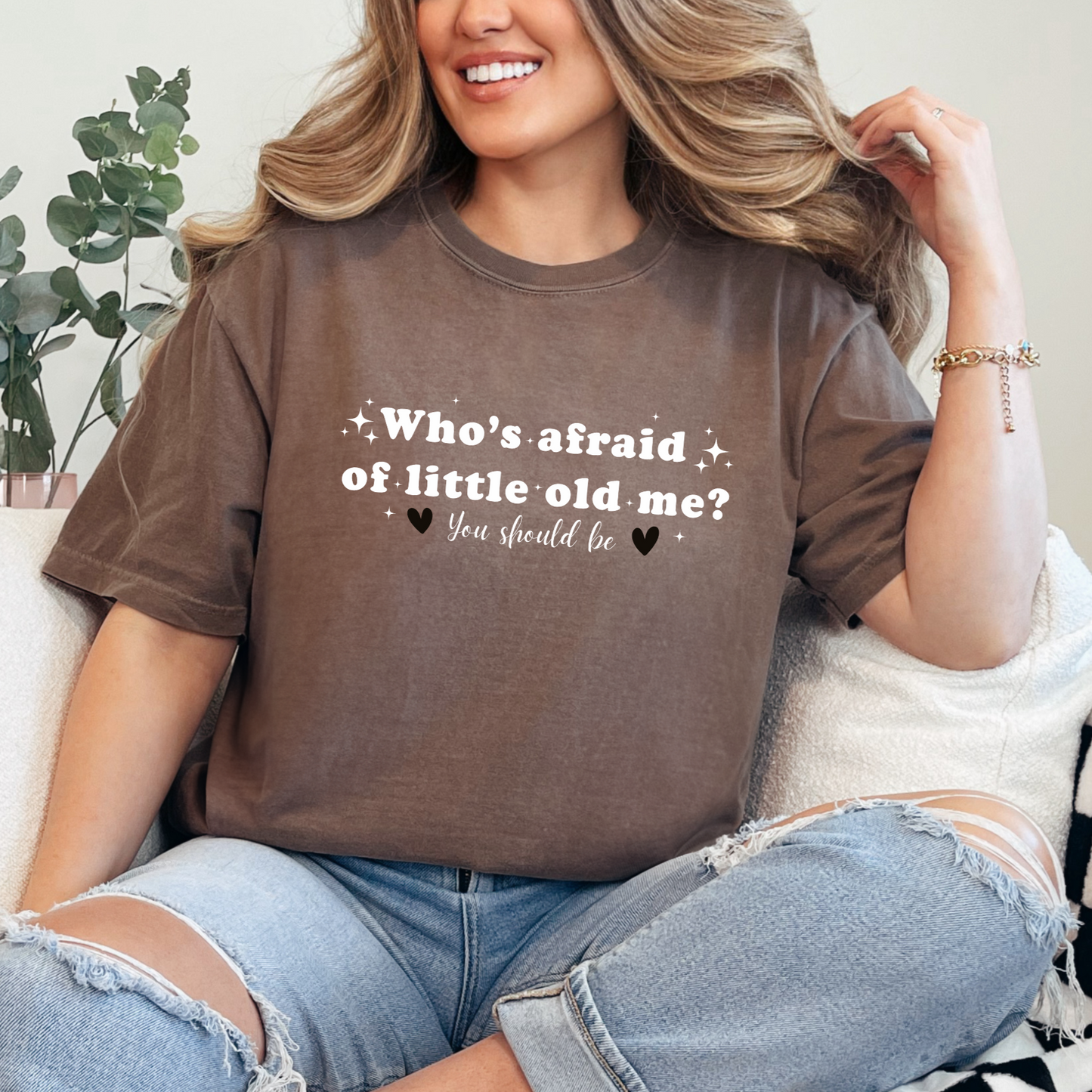 Espresso Comfort Colors Brand T-shirt with Taylor Swift inspired lyrics Who's afraid of little old me? You should be in white font and black hearts on either side of the words You should be.