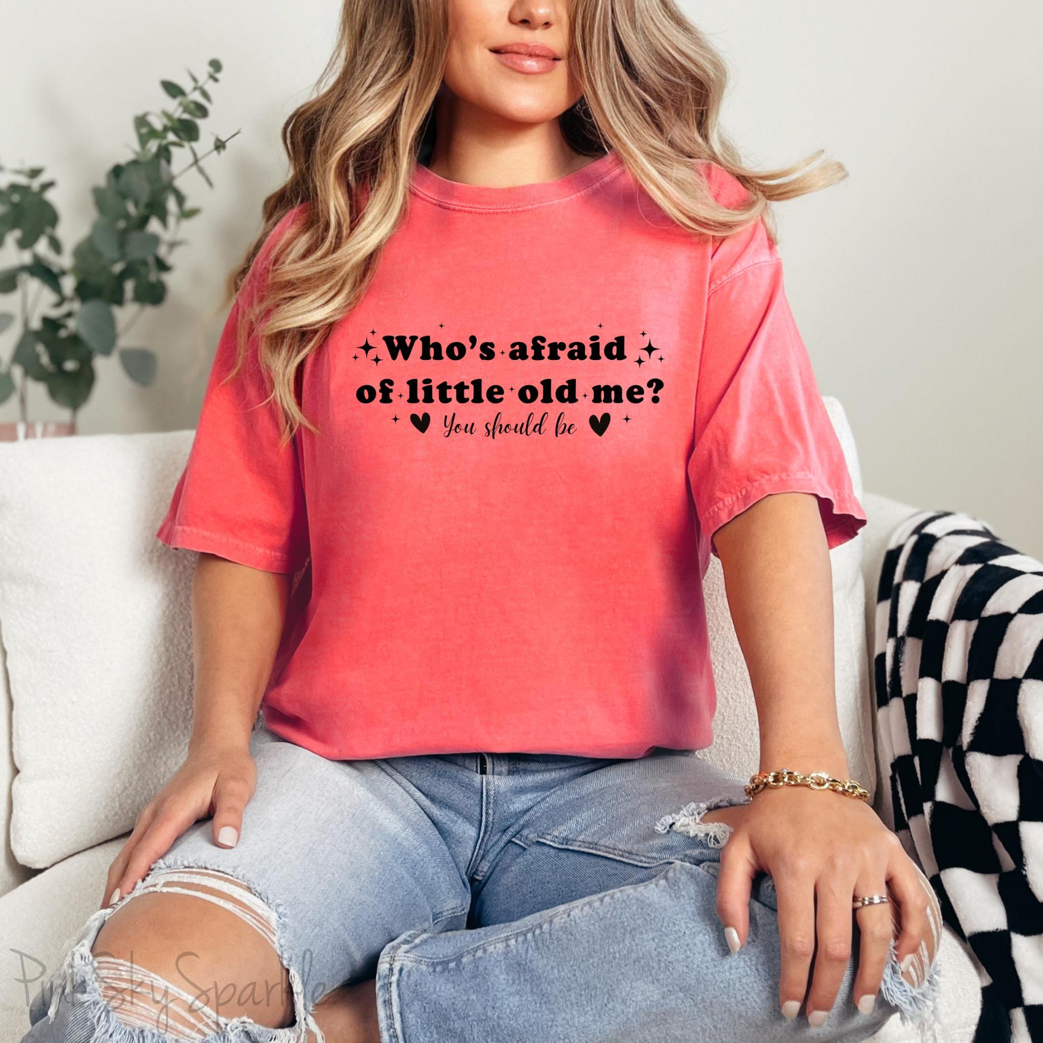 Watermelon color Comfort Colors Brand T-shirt with Taylor Swift inspired lyrics Who's afraid of little old me? You should be in black font.