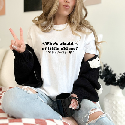 White Comfort Colors Brand T-shirt with Taylor Swift inspired lyrics Who's afraid of little old me? You should be in black font.