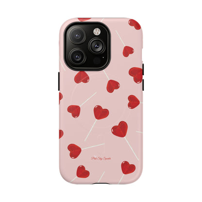 Pink phone case with red heart-shaped lollipop designs, perfect for Valentine’s Day or a playful aesthetic.