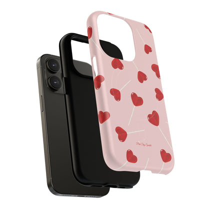 Pink phone case with red heart-shaped lollipop designs, perfect for Valentine’s Day or a playful aesthetic.